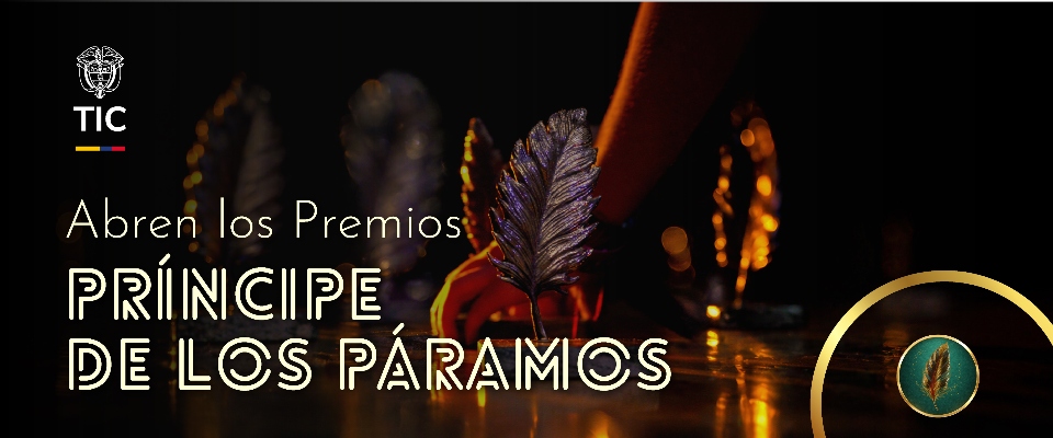 Mano coloca una pluma dorada sobre mesa iluminada; texto anuncia que MinTIC se suma a Premios Príncipe de los Páramos y abre convocatoria
