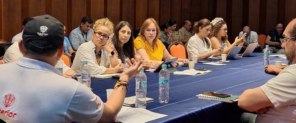 Funcionarios sentados en mesa de trabajo con portátiles y documentos; participan en seguimiento a compromisos con pueblo raizal en San Andrés.